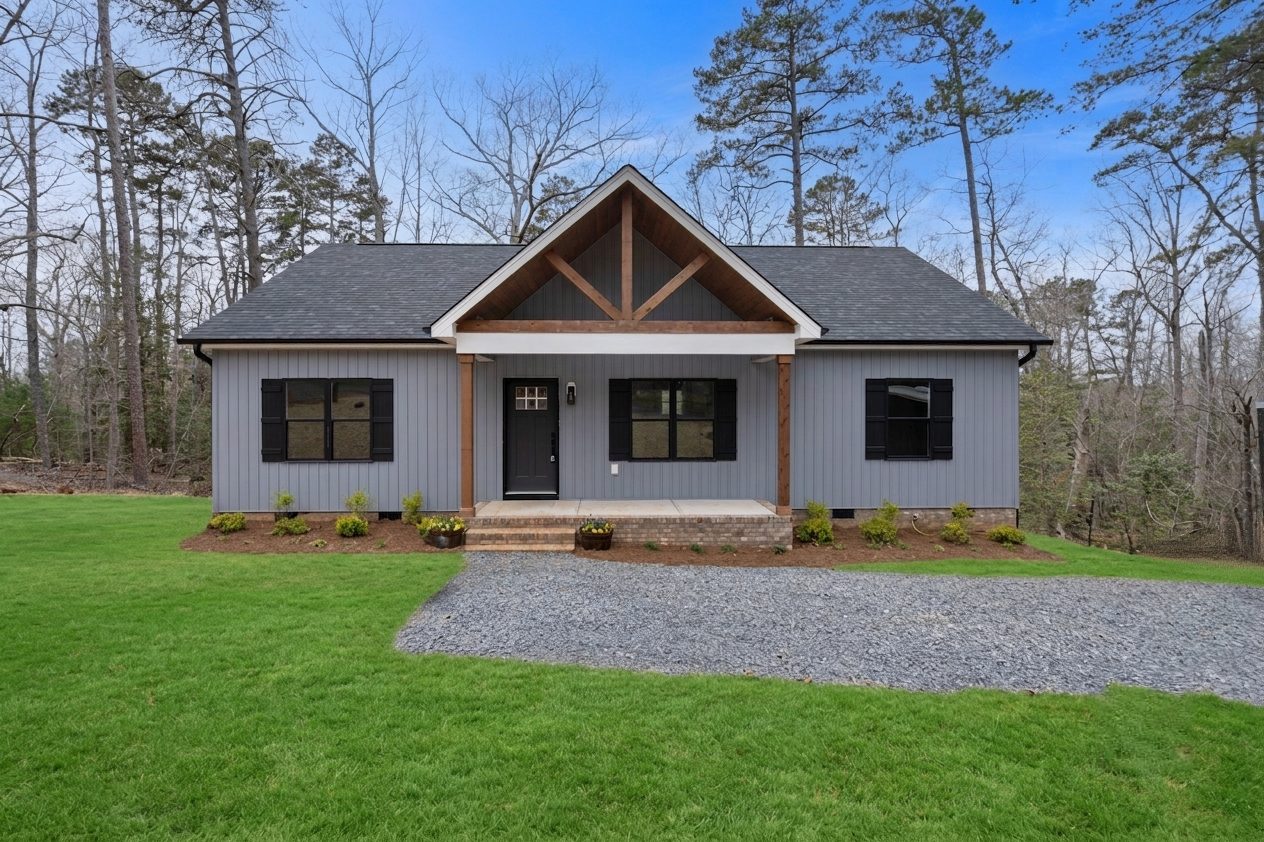 Front of the Lakeside Getaway custom home with gray siding and a timber gable in Mt. Gilead, NC