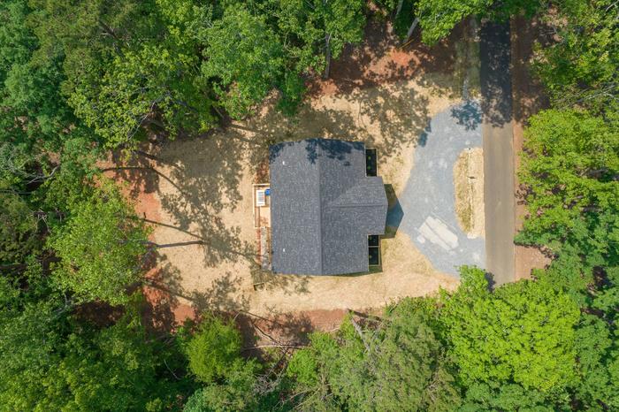 Aerial view of the Hillcrest at Woodrun home on its wooded lot