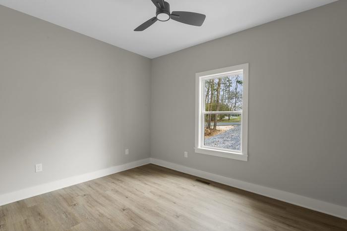 Bedroom with a ceiling fan and window