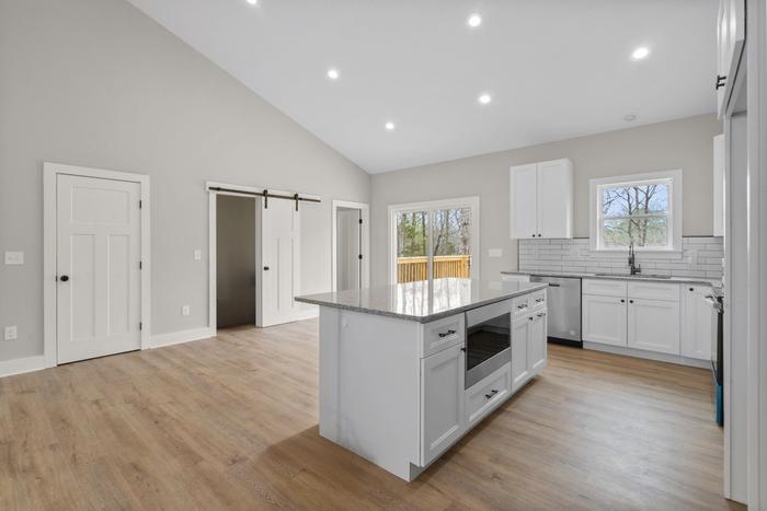 Kitchen island with a sliding barn door to the pantry