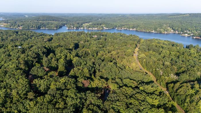Aerial view of the wooded lakeside setting of Raven's Ridge in Mt. Gilead, NC