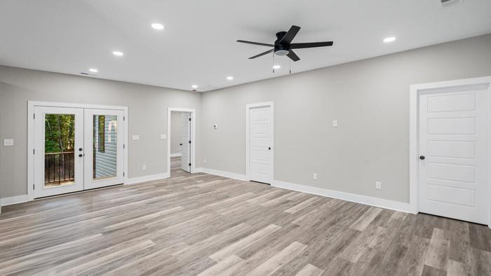 Primary bedroom with French doors to the deck at Raven's Ridge